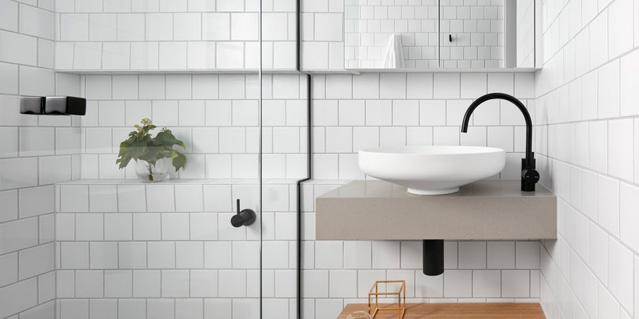 Smarter Bathrooms and Kitchens - an ivory white sink on floated wooden bathroom vanity and elegant black faucet in a modern bathroom design with beautiful white bathroom wall tiles. Beautiful bathroom designs built by bathroom renovations Melbourne specialist