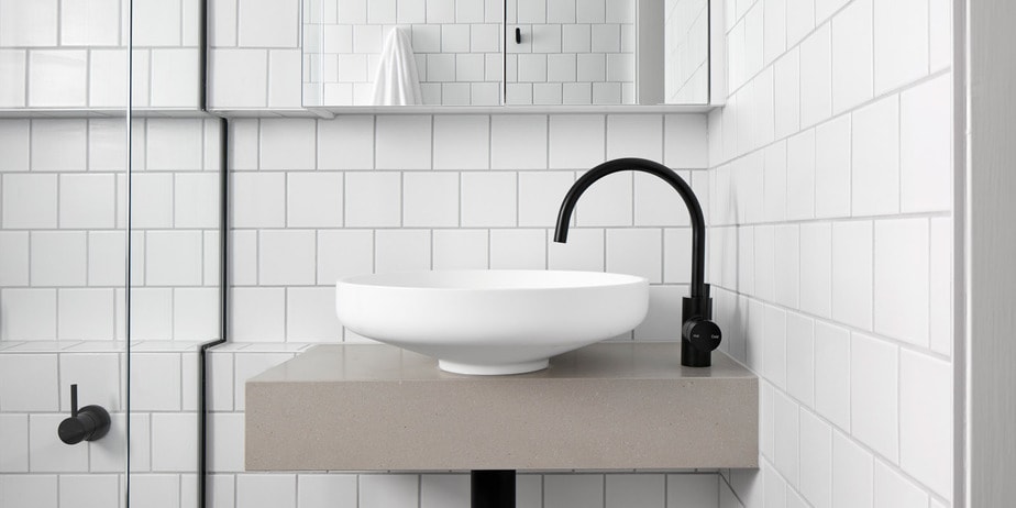 bathroom renovation with ivory white sink and black water tap
