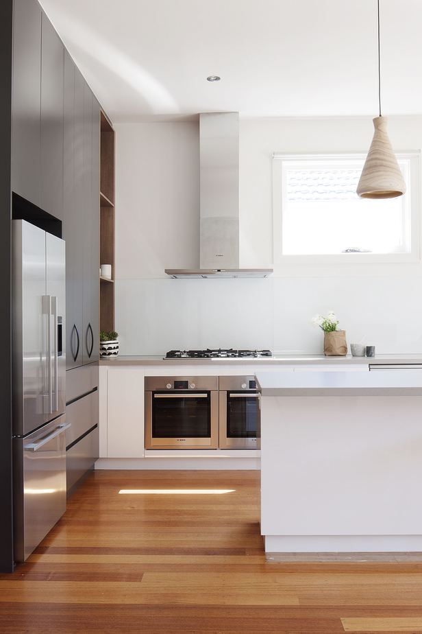 teardrop lampshades, chrome refrigerator, light filled kitchen. Beautiful wooden floors. High end kitchens designed by Smarter Bathrooms.