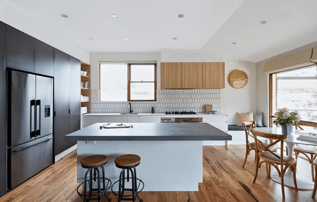 Smarter Bathrooms and Kitchens - a modern kitchen with ivory white furnitures and wooden floor. Beautiful kitchen designs built by kitchen renovation Melbourne specialist